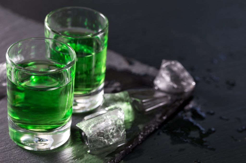 Two glasses of absinthe and melted ice cubes